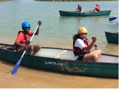 four year 6 pupils rowing in canoes