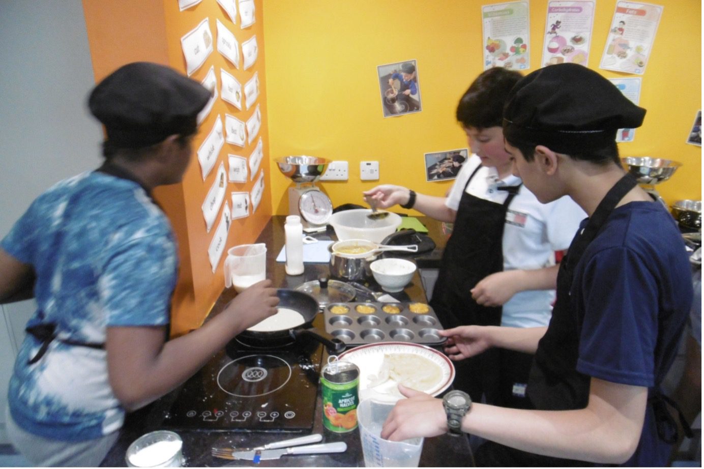 Year 6 pupils making pancakes